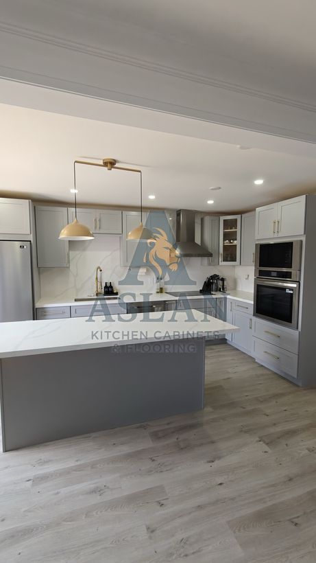 Grey shaker kitchen with a quartz island and full-height marble-look backsplash