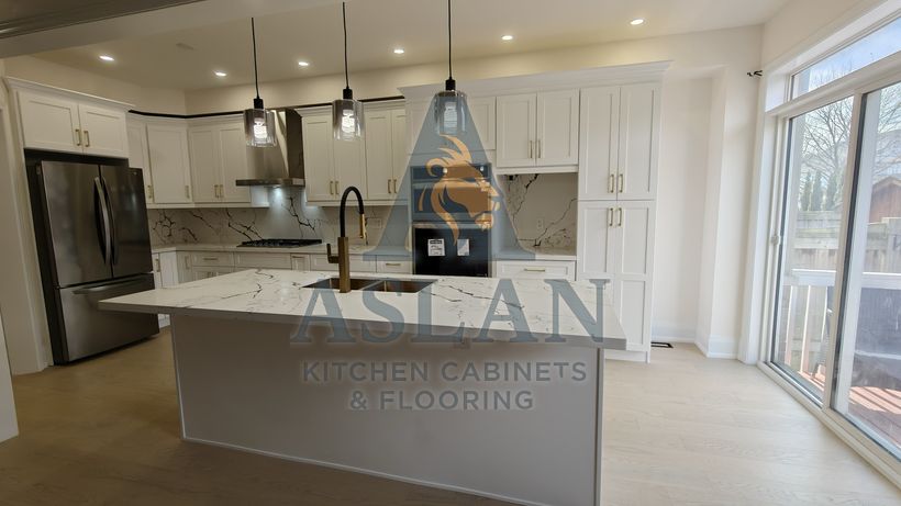 White shaker kitchen with a marble-look quartz island, gold sink and faucet, and matching full-height backsplash