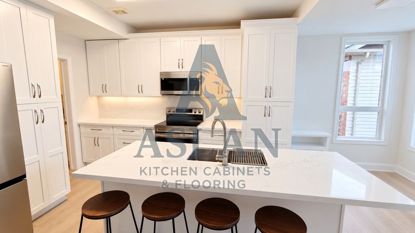 White shaker kitchen with a quartz island, undermount sink and four walnut bar stools