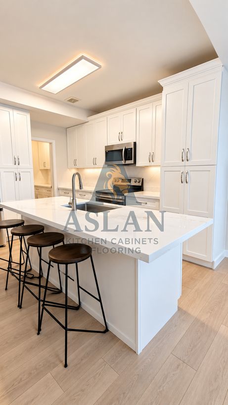 White shaker kitchen with quartz island and walnut stools, side view