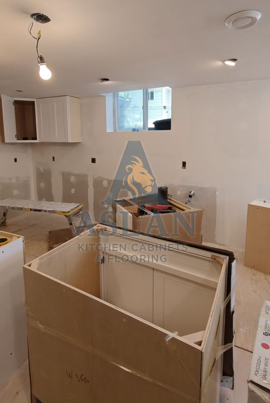 Island cabinet being set during a basement kitchen installation