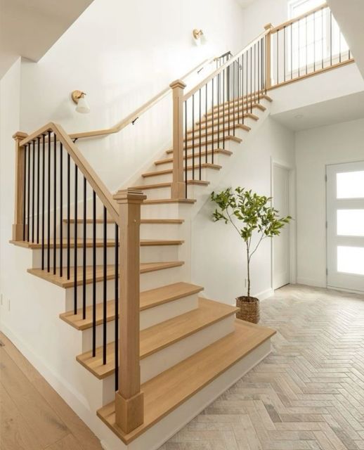 Staircase with oak treads, square newel posts and black iron spindles
