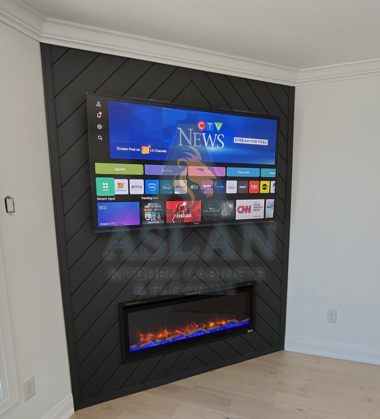 Corner TV wall in black herringbone panelling with a linear electric fireplace