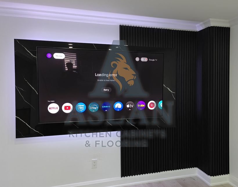 Black marble-look TV panel with backlighting, set against a black slatted feature wall