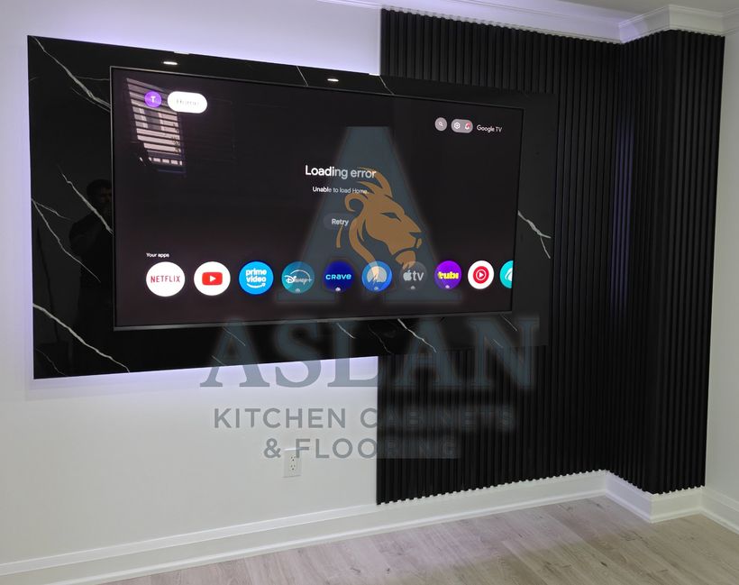 Floating black marble-look TV wall with LED glow and full-height black slat panels