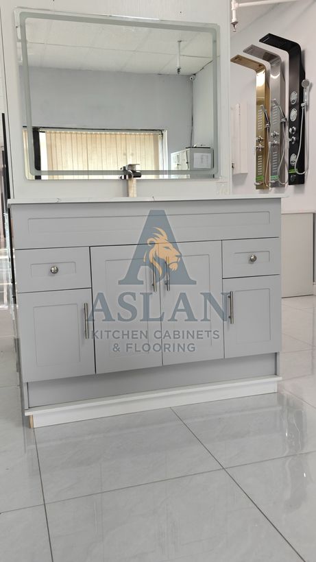 Grey shaker bathroom vanity with quartz top and LED mirror